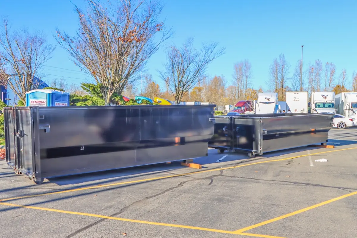 Professional dumpster rental service with roll-off container on residential driveway in Atlantic Beach